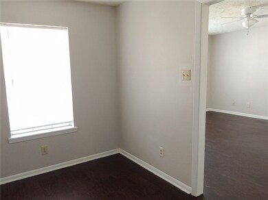 Empty room featuring a ceiling fan, baseboards, an