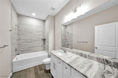 Full bathroom featuring hardwood / wood-style floo