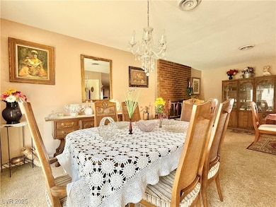 Dining room with a notable chandelier and light ca