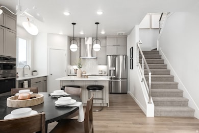 A bright, airy space where the kitchen and dining room come together in perfect harmony. *model