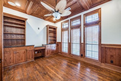 Unfurnished office featuring ornamental molding, wooden ceiling, coffered ceiling, and built in desk