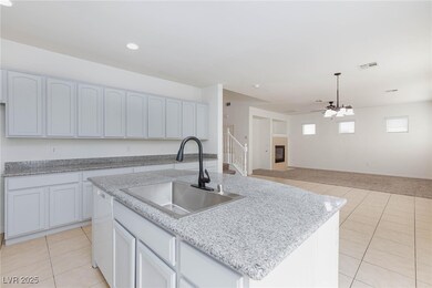 Kitchen with light tile patterned floors, a sink,