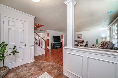The inviting entryway is adorned with classic wain