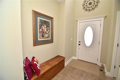 Elegant entry with tile floors and boot bench with