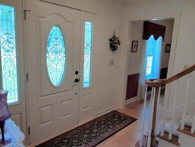 Beautiful entry Foyer has wood flooring and leaded