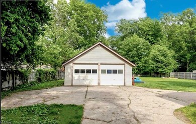 Garage featuring garage and a lawn