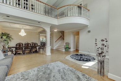 Living room with a towering ceiling, arched walkwa