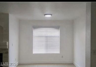 Unfurnished room with light tile patterned floors and a fireplace