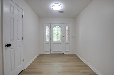 Foyer entrance with light wood finished floors and