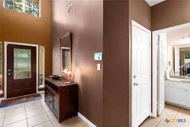 Entry boast tall ceilings with natural light.