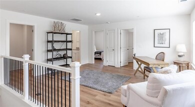 Living area featuring light wood-style floors, recessed lighting, and baseboards