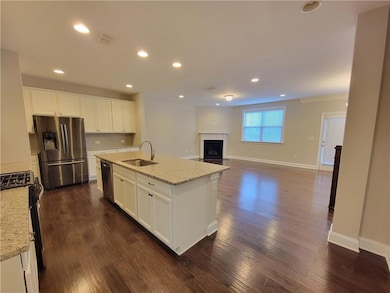 Kitchen featuring stainless steel appliances, a si