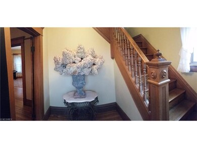 Large foyer with hardwood floors, original wood tr