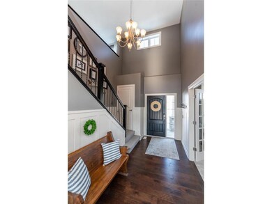 Large two-story entry with hardwood floors, beadbo