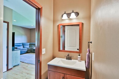 A half bath with an upgraded vanity is convenientl