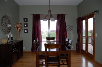 The dining room features hardwood floors, peaceful