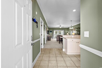 Foyer entrance featuring ornamental molding, light