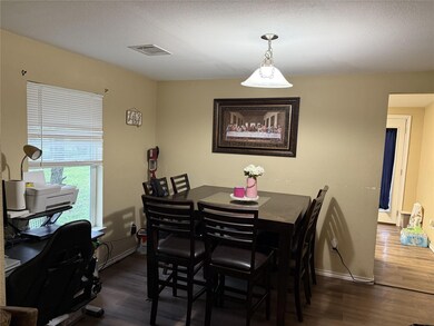 Dining space with dark wood finished floors, visi