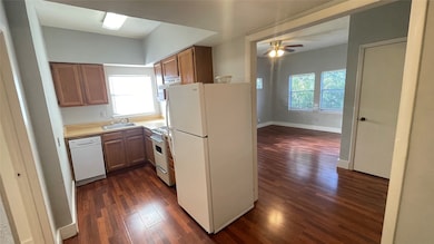 Cozy kitchen with Euro-style electric range, dishwasher and fridge.