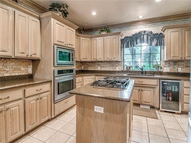 Kitchen has solid surface counter tops...wine frid