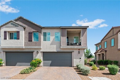 View of property with a garage, decorative drivewa