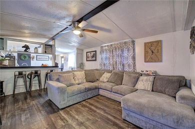 Living room featuring lofted ceiling with beams, c