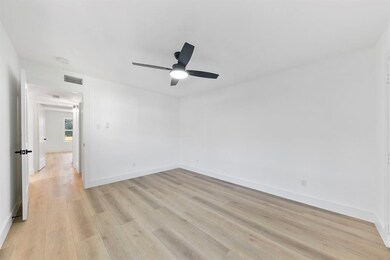 This photo showcases a bright, spacious bedroom wi