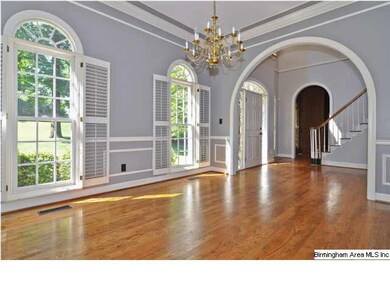 Dining Room with tray ceiling, wainscoting and bea
