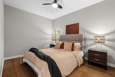 Bedroom featuring baseboards, wood finished floor