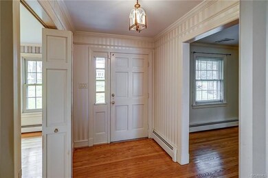 Foyer has hw floors, sidelight, coat closet and ac