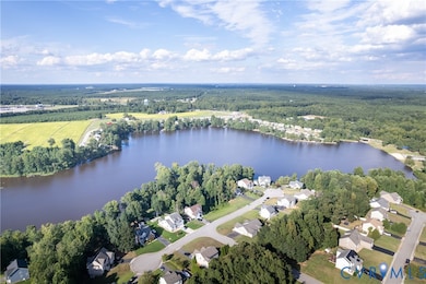 Aerial overview of property's location with a nearby body of water and nearby suburban area