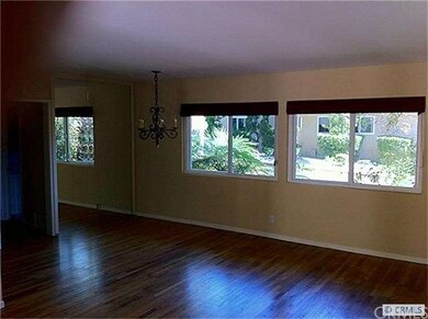 Living Room/Dining Area with hardwood floors and l