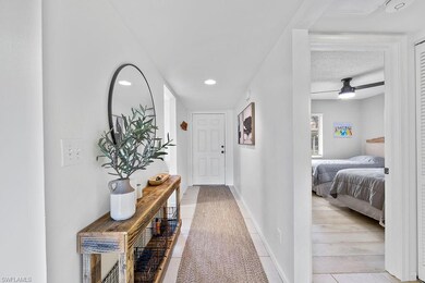 Hall with a textured ceiling, recessed lighting, and baseboards