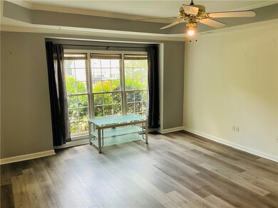 Empty room with crown molding, a ceiling fan, and wood finished floors