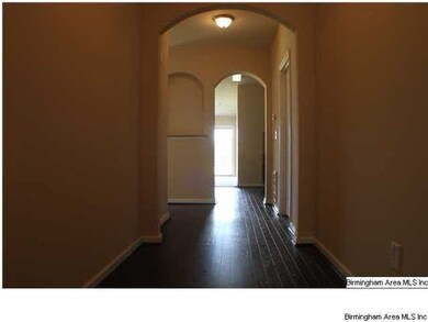 ENTRY FOYER WITH HARDWOOD FLOORING AND ARCHED OPEN