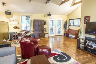 Pretty hardwood floors.  French doors to large cov