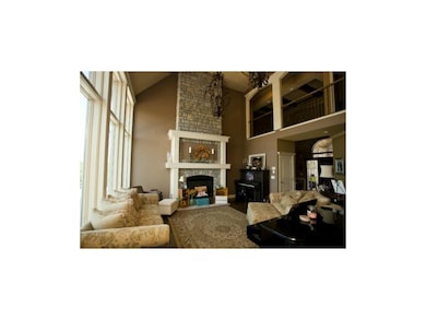 Living room with floor to ceiling  windows and  st