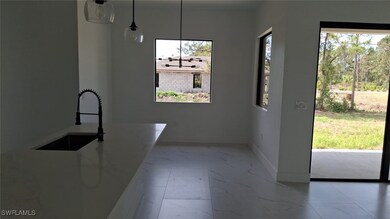 Unfurnished dining area with baseboards, a sink, a