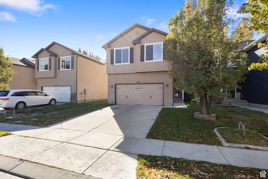 View of front facade featuring driveway, a front lawn, and a garage
