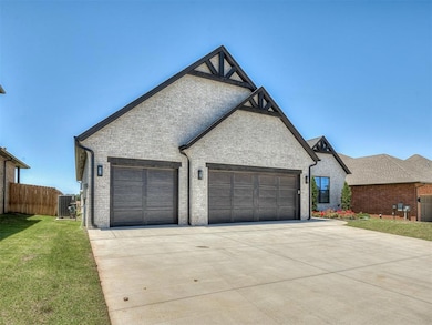 French country style house with a garage, driveway, brick siding, and cooling unit