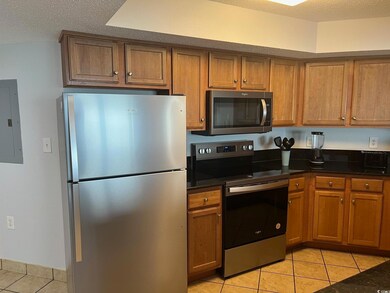Kitchen featuring a textured ceiling, stainless st