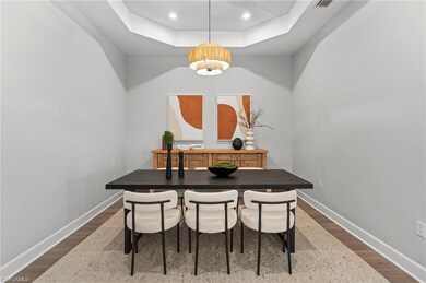 Dining space with dark wood-type flooring, a notab