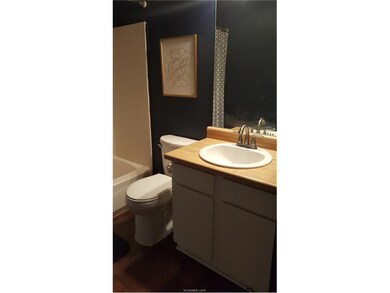 Full bathroom featuring vanity, wood-type flooring