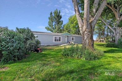 Back of property featuring a yard and crawl space