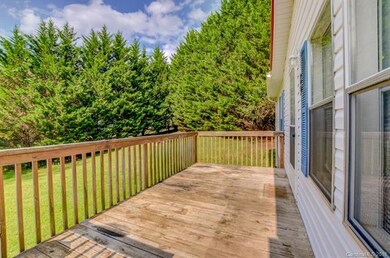 The front deck overlooks the lush greenery and lar