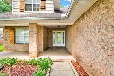 Doorway to property with roof with shingles and br