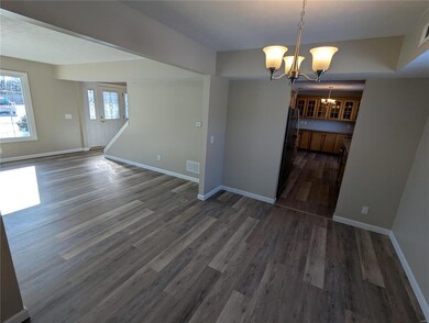 Unfurnished dining area featuring dark hardwood / wood-style floors and a chandelier