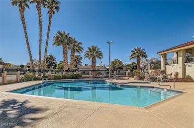 Pool with a patio area and fence