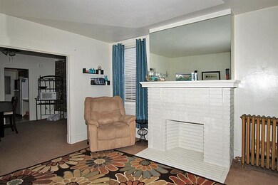 First floor living room with decorative fireplace.