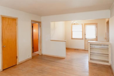 Spare room featuring a chandelier, light wood-styl